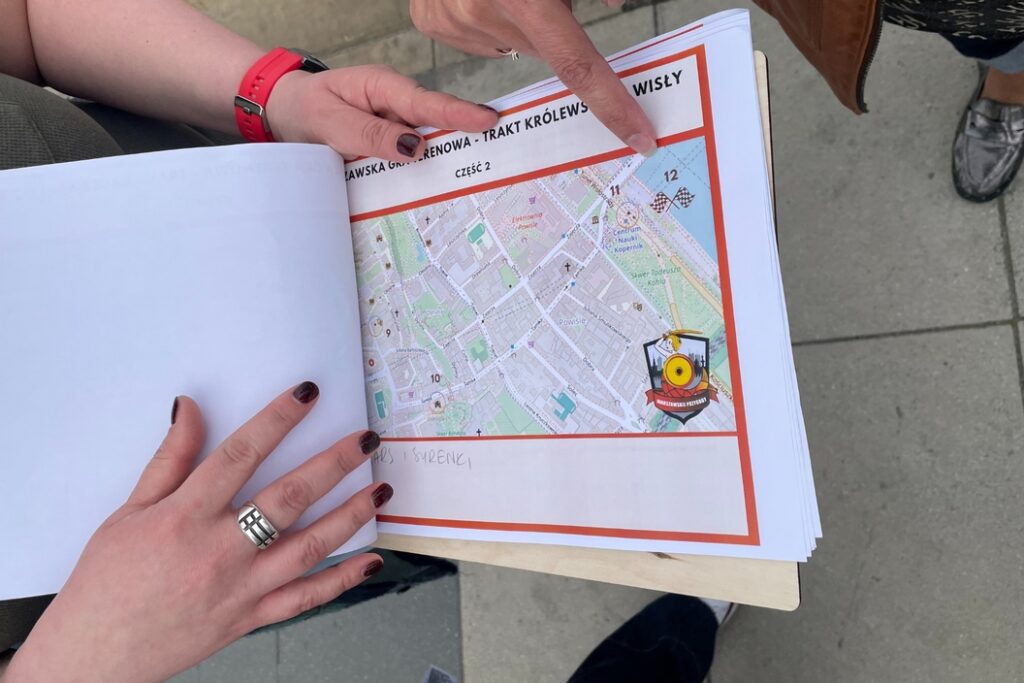 Uczestnicy gry miejskiej w Warszawie z mapą w ręku
